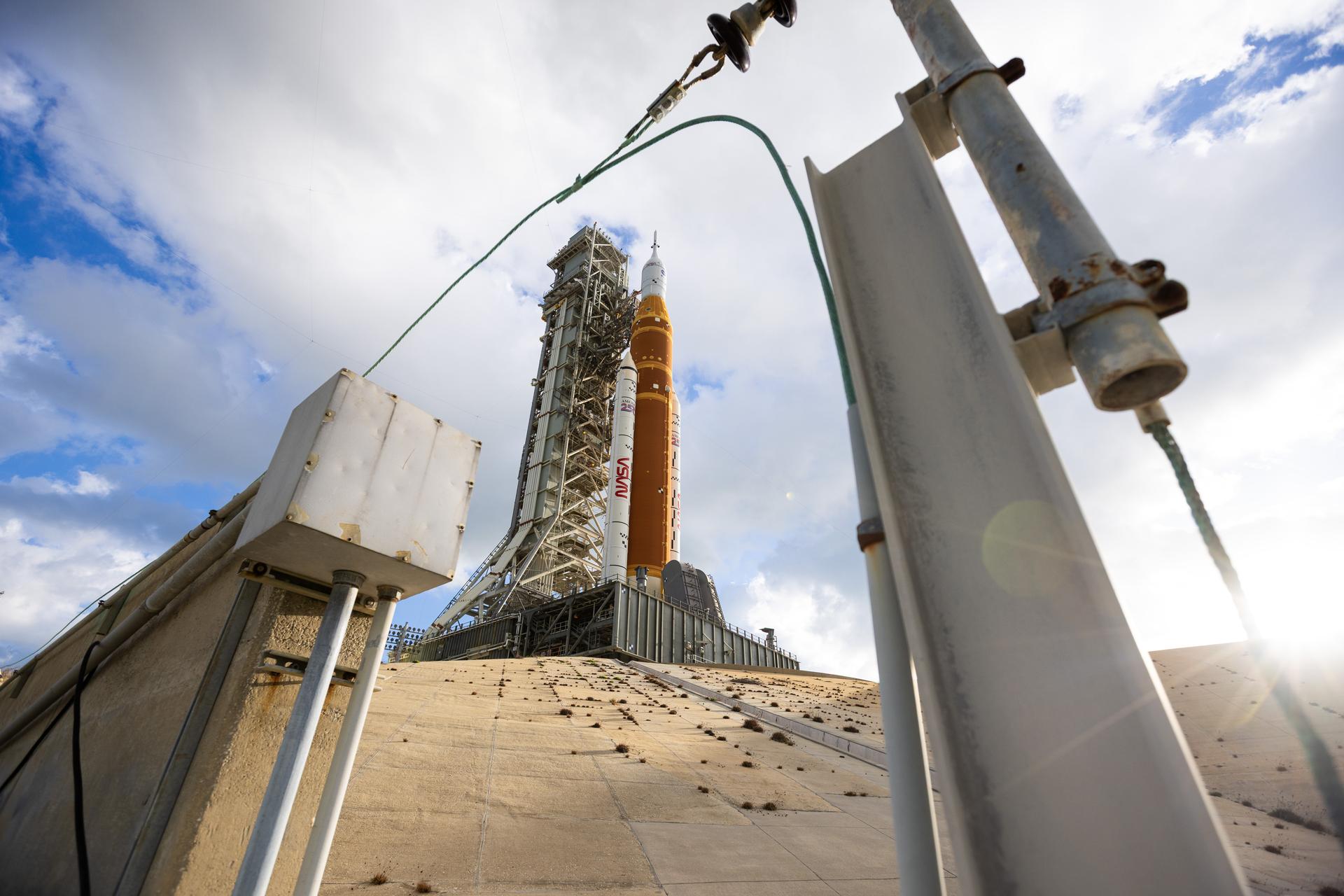 This image shows NASA’s SLS (Space Launch System) and Orion spacecraft rolling out of the Vehicle Assembly Building at NASA’s Kennedy Space Center. NASA's massive Crawler-Transporter, upgraded for the Artemis program, carries the powerful SLS rocket and Orion spacecraft on the Mobile Launcher from the Vehicle Assembly Building to Launch Pad 39B at Kennedy Space Center in preparation for the Artemis II mission.
